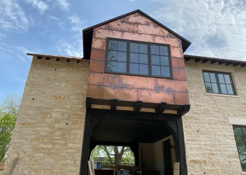 Copper metal panel facade on a stone building for Skylight Installation in Panthersville