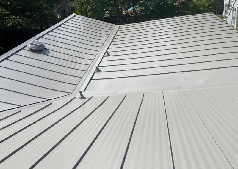 Solar attic fan installed on a metal roof for Roof Ventilation in Panthersville